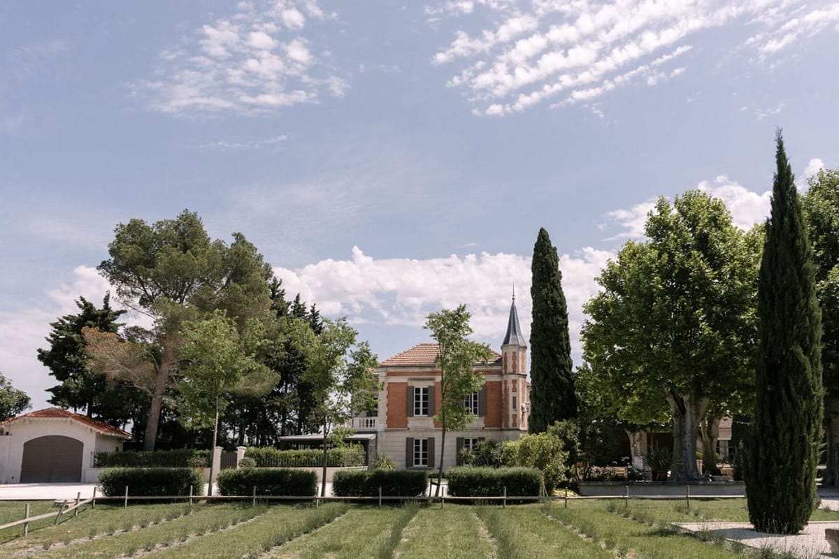 Aerial view of Mas D'Arvieux turret and chateau framed by lavender rows