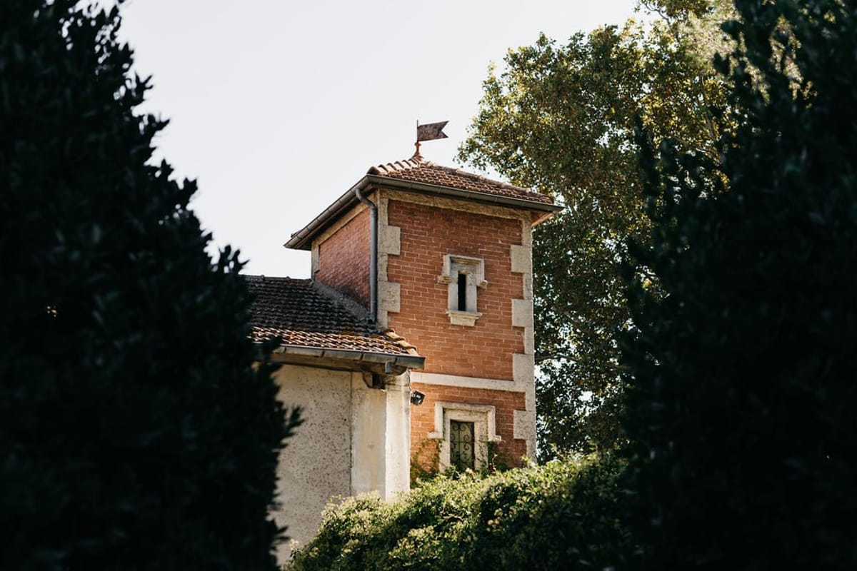 Mas D'Arvieux corner turret seen through the garden trees
