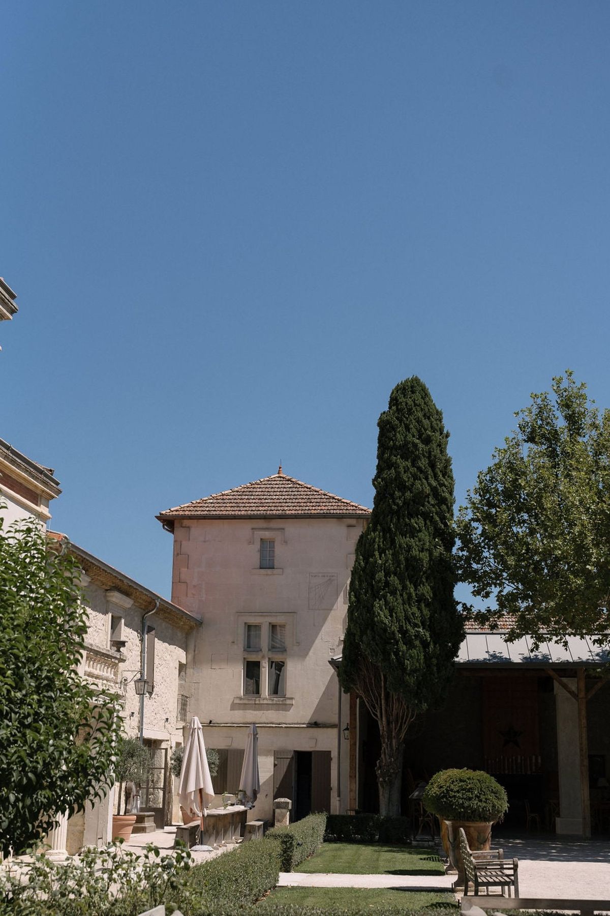 Mas D'Arvieux corner turret and outbuilding seen against a clear sky