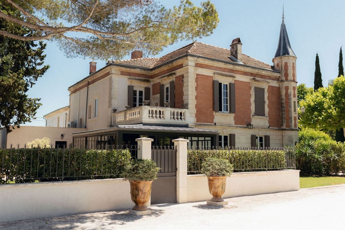 Mas D'Arvieux chateau facade and turret seen from the gated driveway