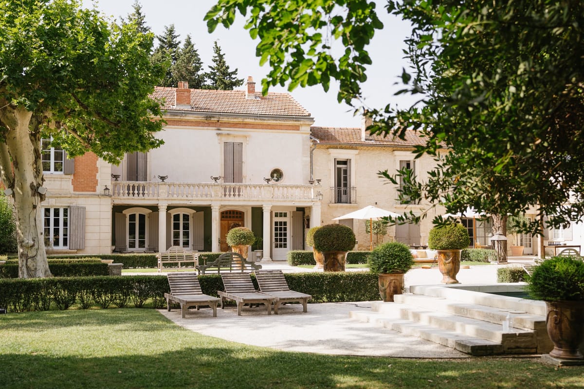 Mas D'Arvieux chateau, gardens and pool edge seen from the lawn