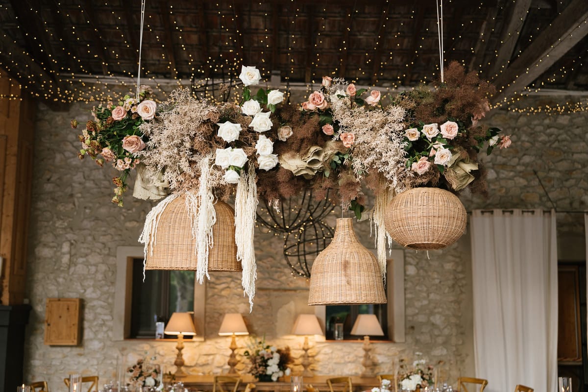 Mas D'Arvieux reception floral chandelier installation with roses and dried grasses