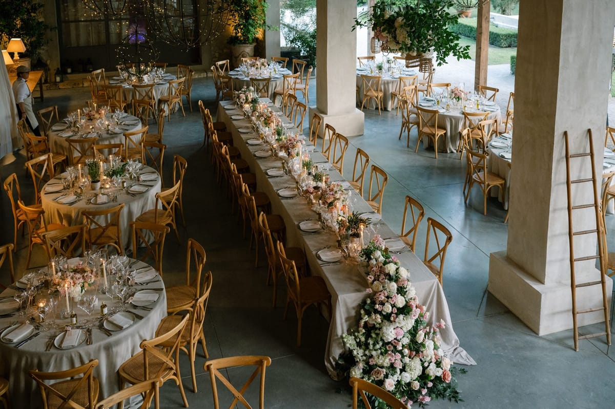 Mas D'Arvieux covered reception terrace set with long tables and floral runners