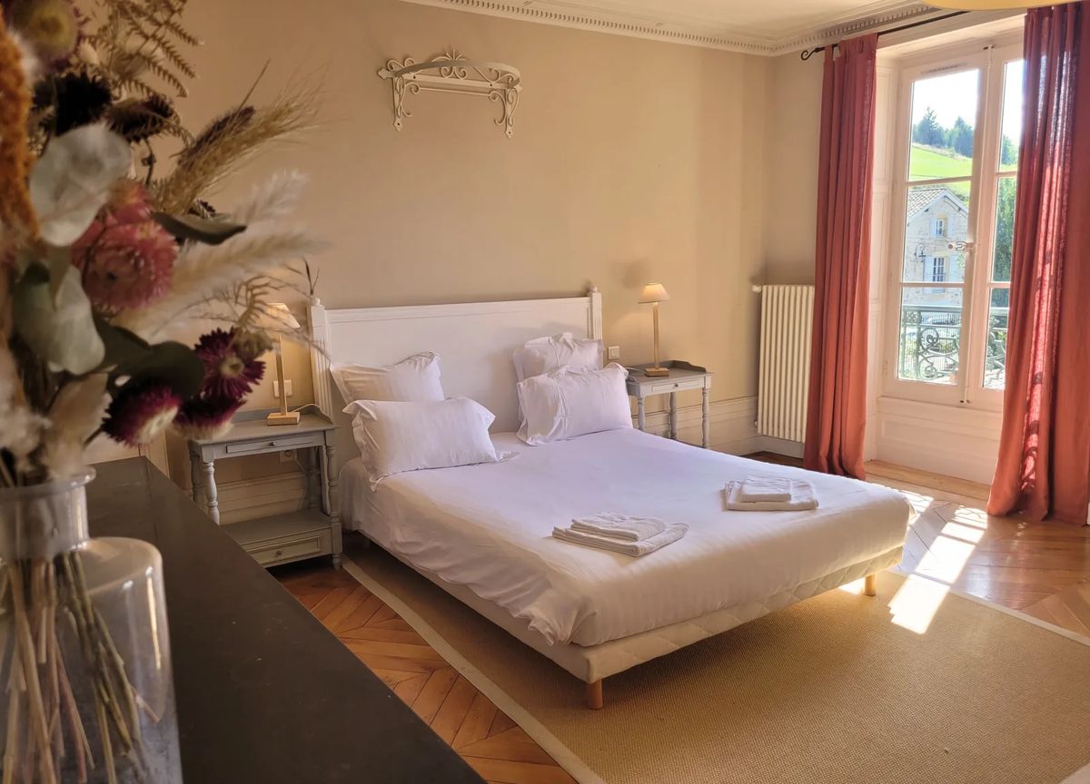 Bedroom at Domaine de Vavril with French doors overlooking the village