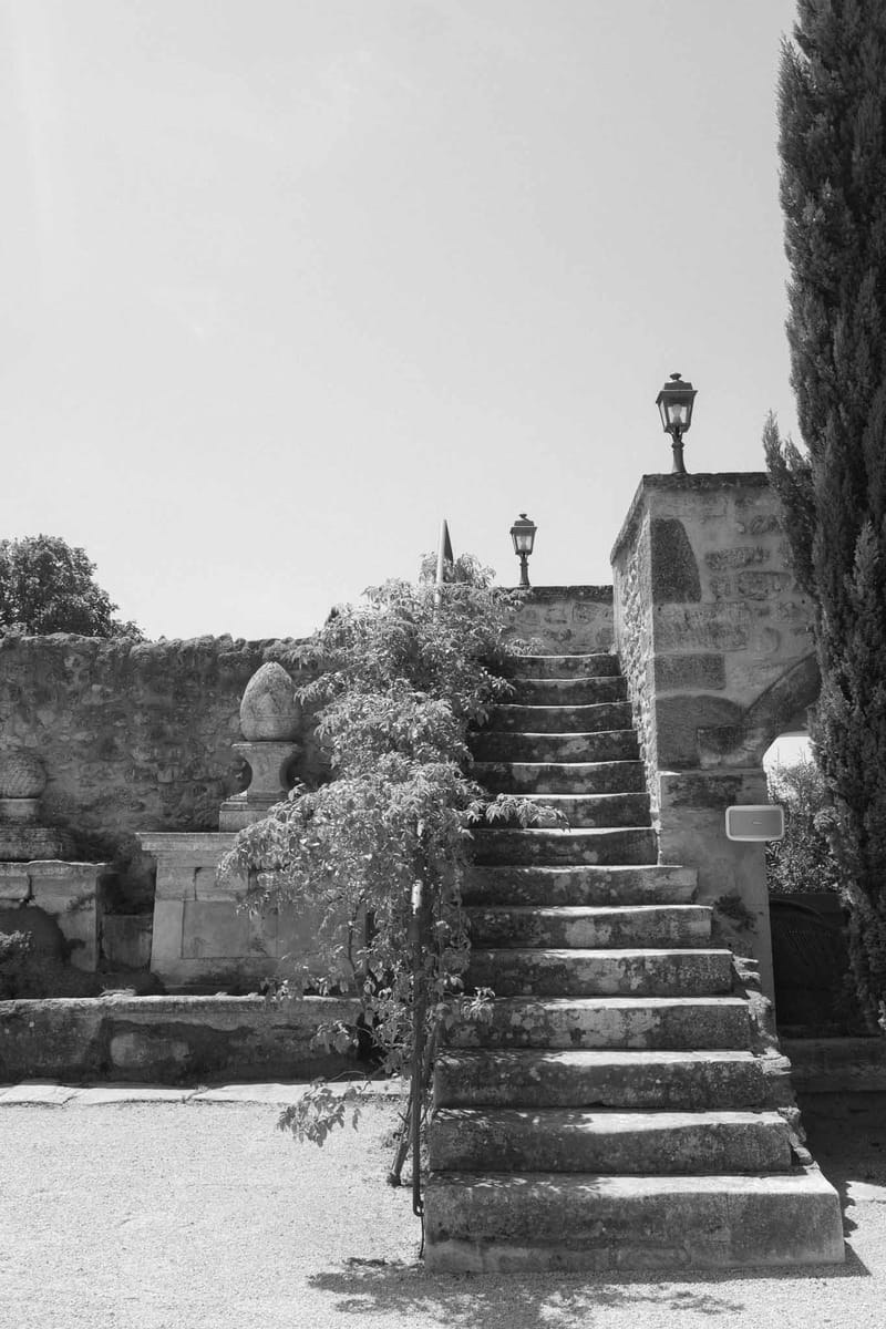 Historic stone staircase with lanterns and cypress trees at stone courtyard venue