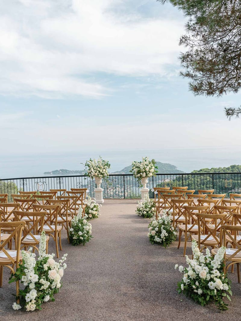 Outdoor wedding ceremony setup on Mediterranean coastal terrace with sea view