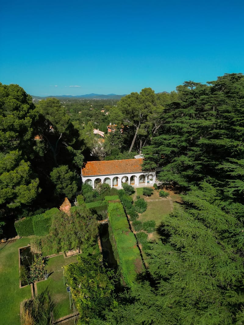 Aerial view of arched orangery and terraced gardens at Domaine Rocabella, French Riviera