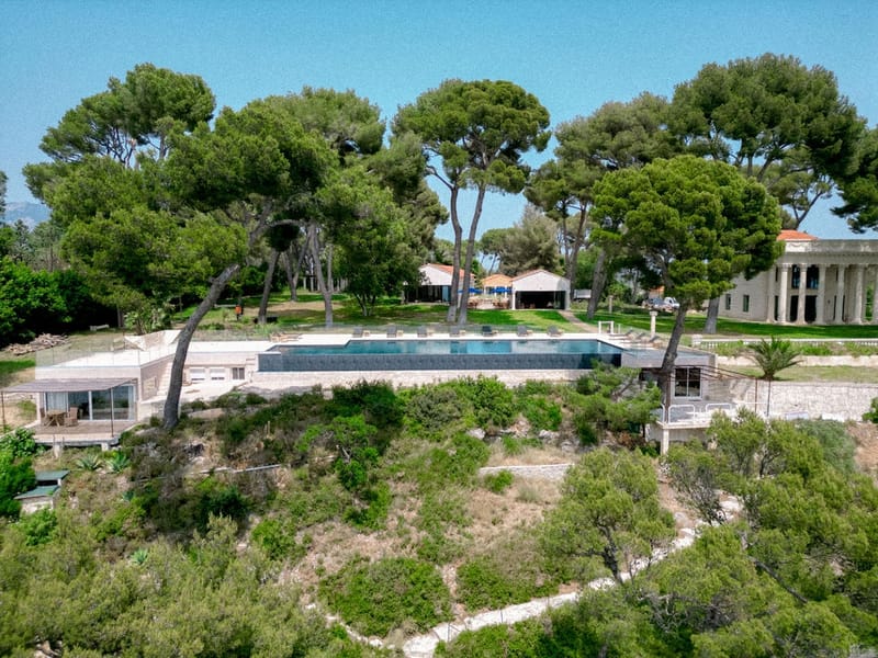 Aerial view of swimming pool and villa among pine trees at Domaine Rocabella, French Riviera