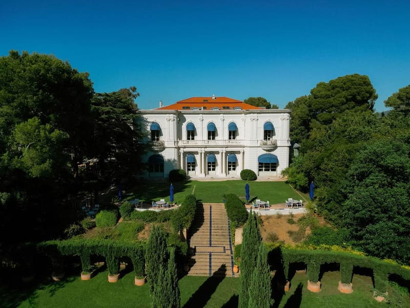 Wide aerial view of villa and Italianate gardens with cypress hedges at Domaine Rocabella, French Riviera