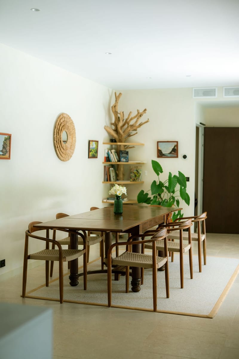 Modern dining room with wooden table and driftwood decor at Domaine Rocabella, French Riviera