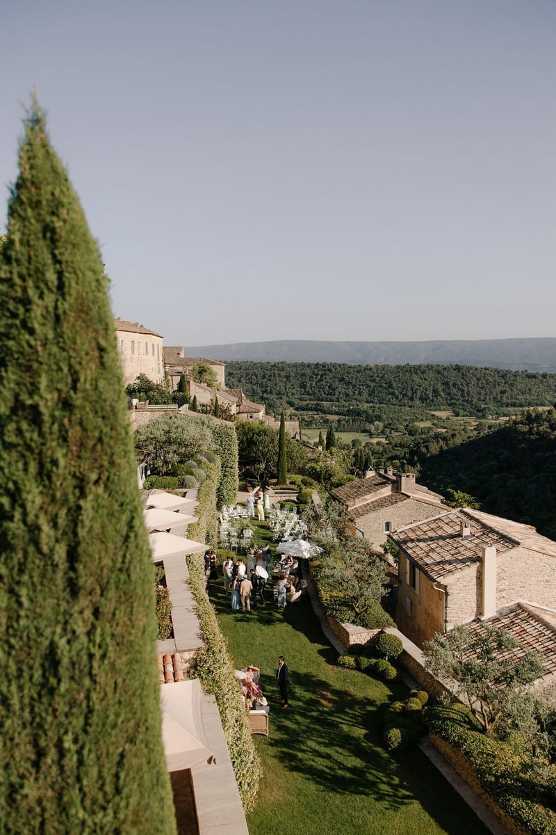 Aerial garden view with cypress and parasols at Airelles Gordes La Bastide, Provence