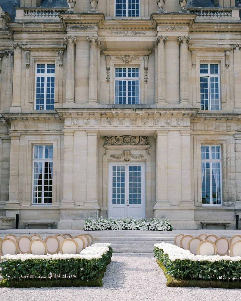 Chateau facade with white rose borders at Chateau Saint-Martin-du-Tertre