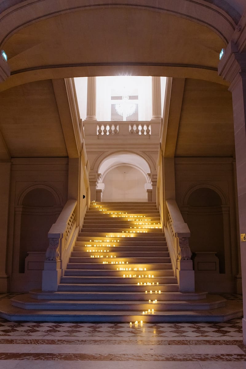 Candlelit grand staircase at Chateau Saint-Martin-du-Tertre
