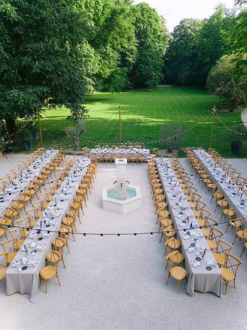 Drone view of reception tables around fountain at Chateau des Barrenques