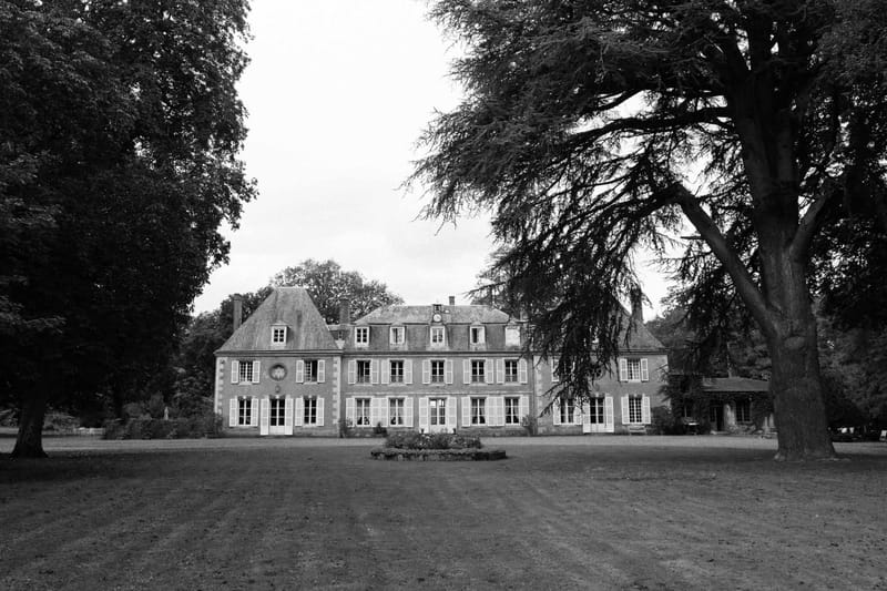 Black and white photo of exterior of in a garden