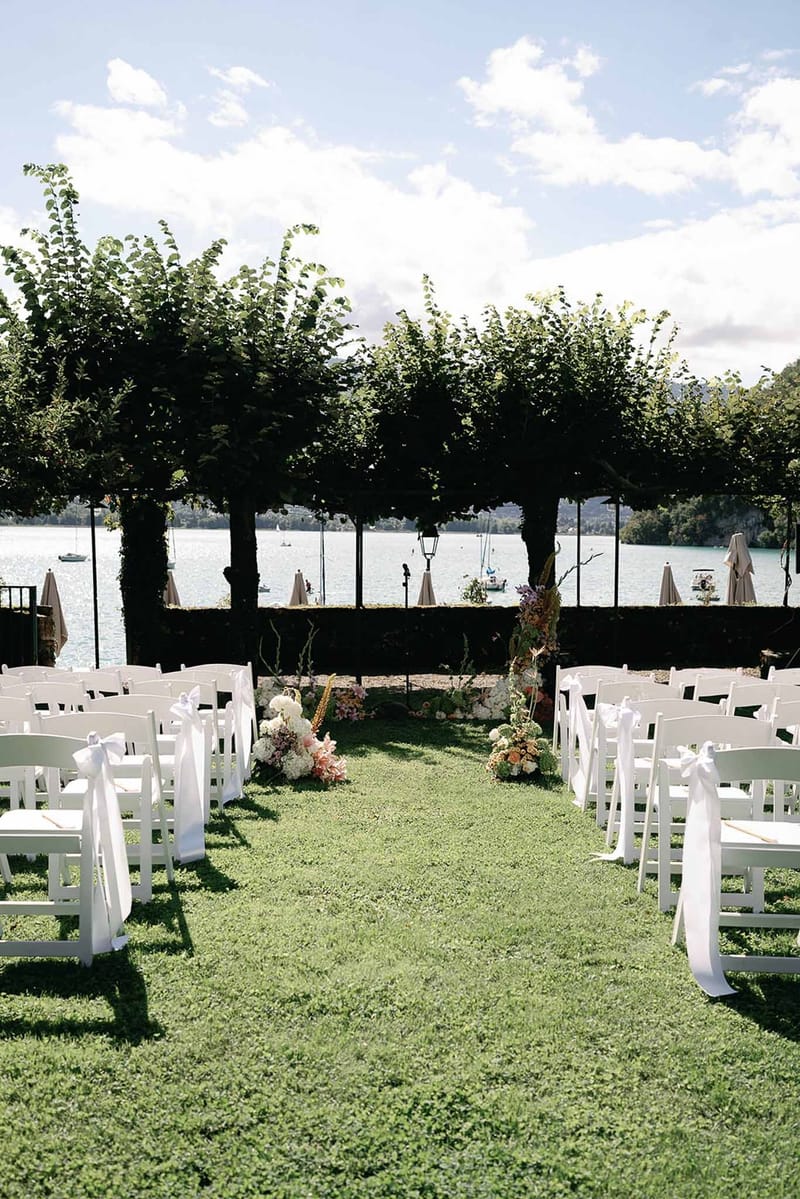 Ceremony aisle looking toward tree altar with lake behind at Abbaye de Talloires