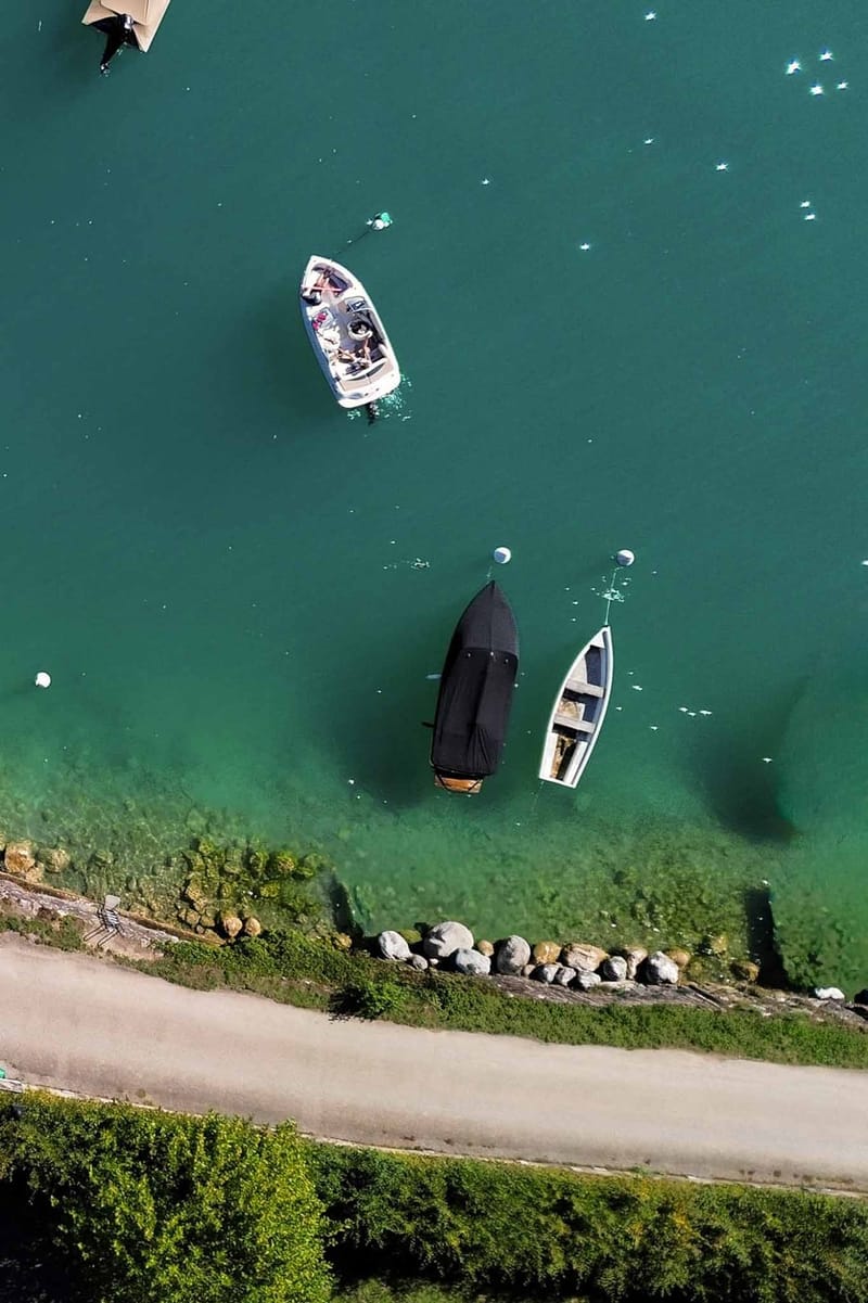 Aerial drone view of Abbaye de Talloires with lake and gardens