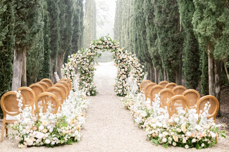 Wedding ceremony setup in a garden with white roses
