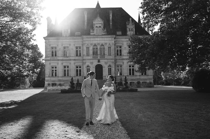 Black and white photo of wedding reception table setting with white roses