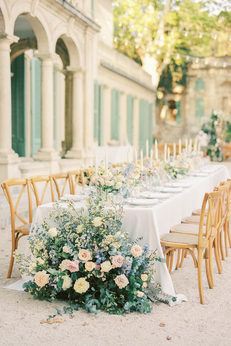 Wedding reception table setting in a garden with white roses