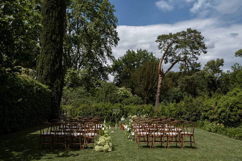 Wedding ceremony setup in a garden with hydrangeas