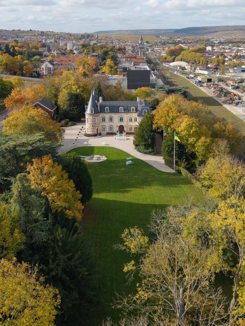 Aerial drone view of Château Comtesse Lafond with autumn trees in Épernay