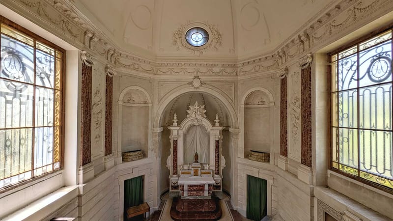 Private chapel interior with domed ceiling, red marble pilasters, and Baroque carved stone altar