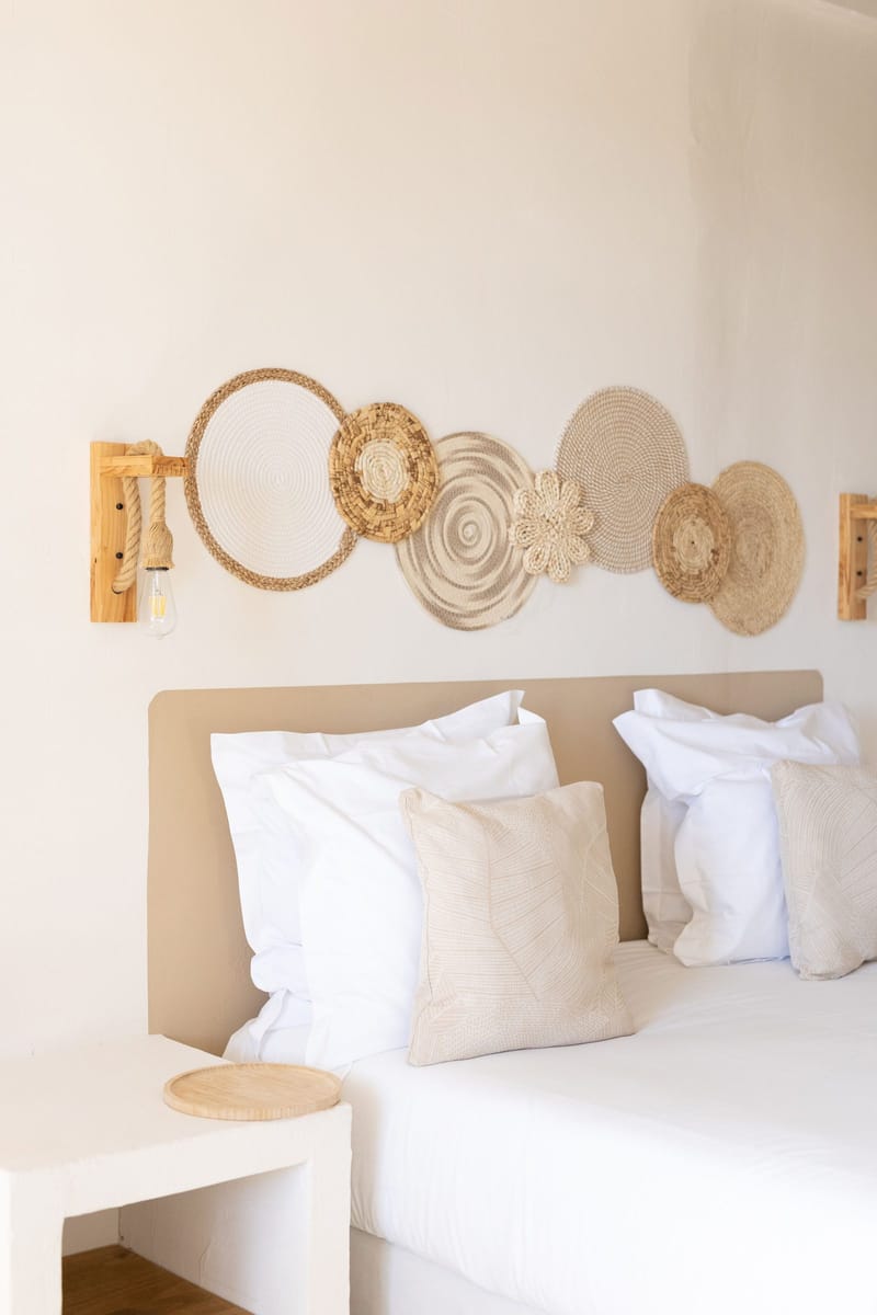 A bedroom with woven wall decor