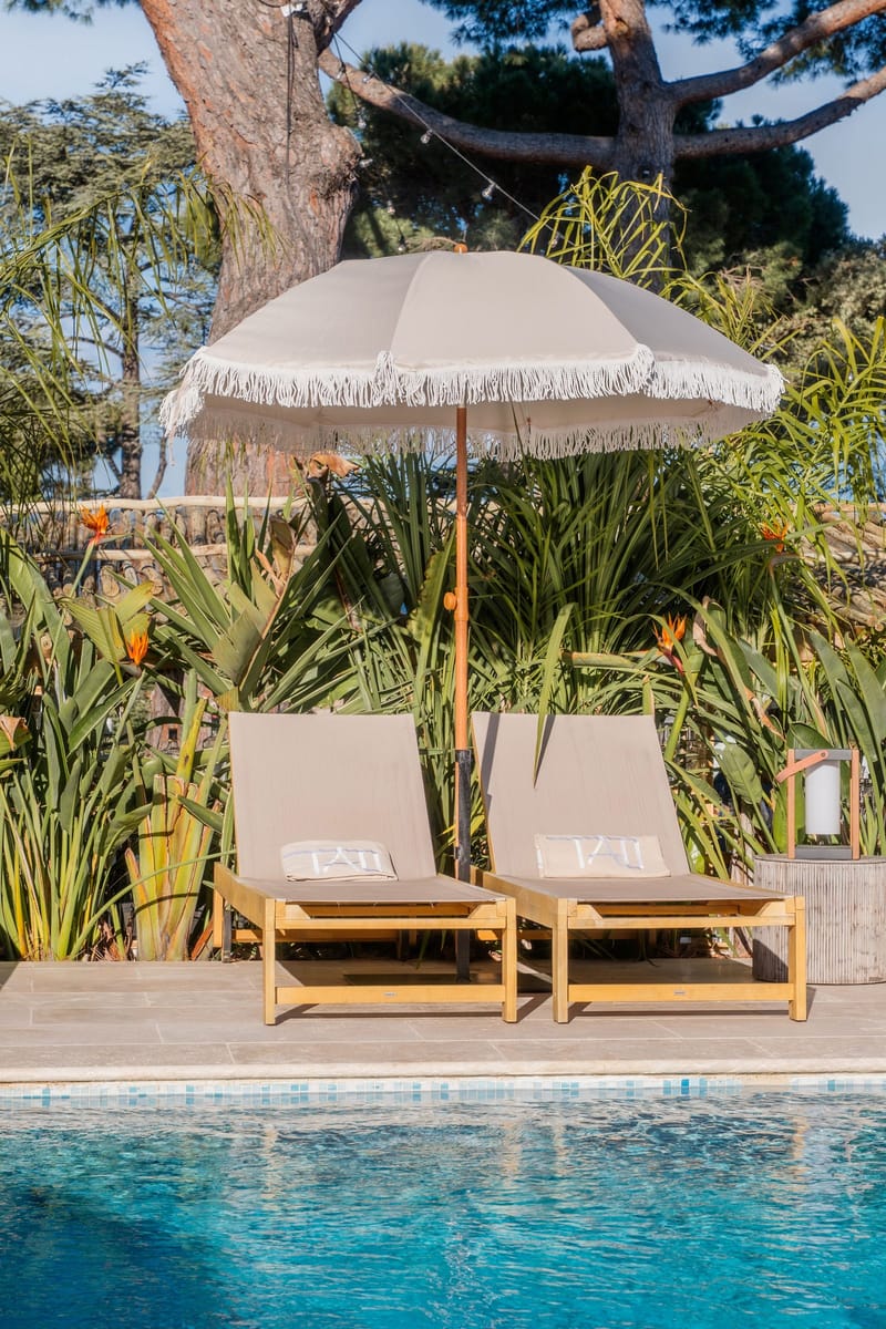 Sun loungers and a parasol beside the pool