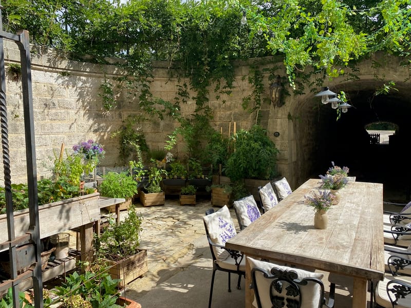 An outdoor dining terrace in the dry moat at Château Changeux