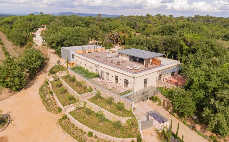 Domaine de Blacailloux aerial view of renovated bastide with rooftop terrace and terraced gardens in Provence