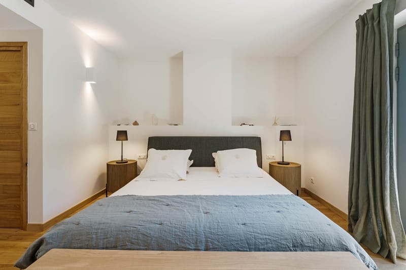 Domaine de Blacailloux bastide bedroom suite with blue linen bedding and minimalist Provencal decor