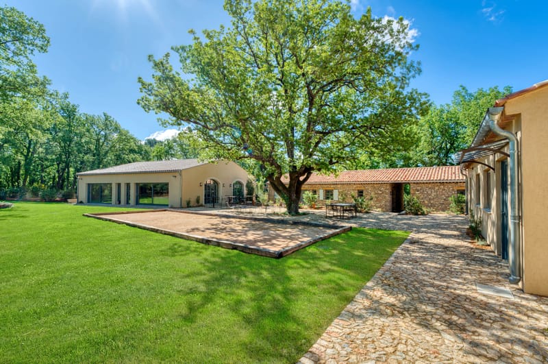 Domaine de Blacailloux estate buildings with mature oak tree and petanque court