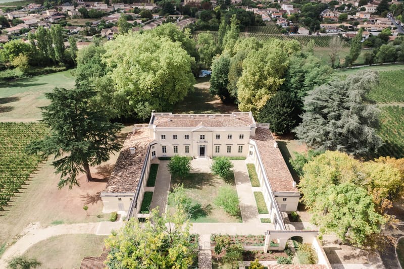 Aerial drone view of Chateau de l'Hospital with its walled parterre garden and estate vineyards