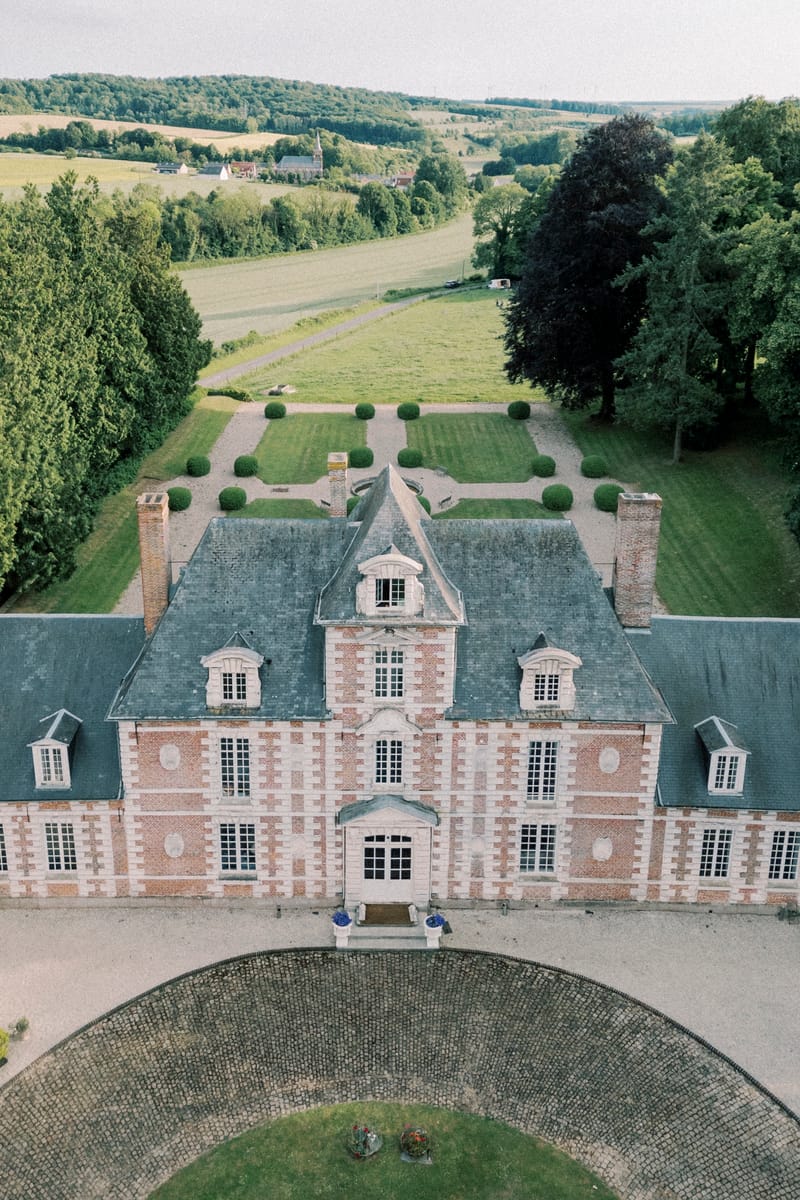 Aerial view over the château roof to the formal parterre and open countryside beyond