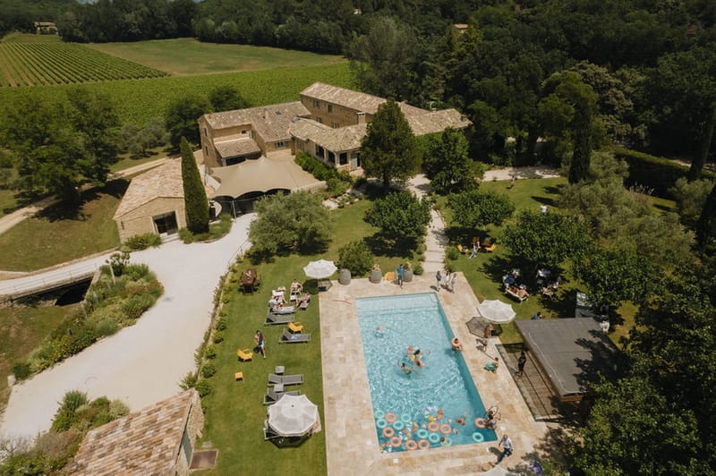 Aerial view of Domaine de Valbonne Provencal stone hameau with swimming pool and vineyards