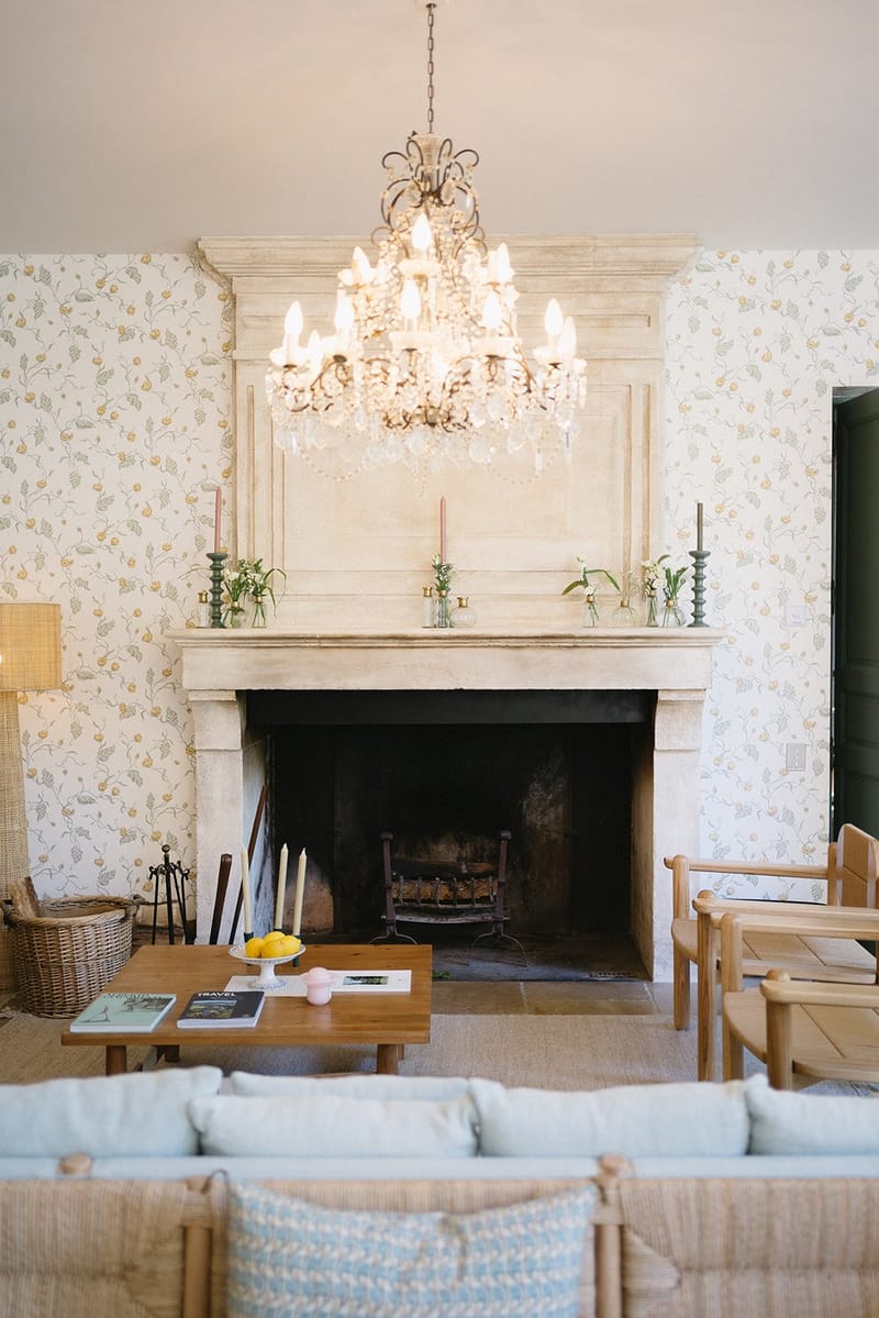Interior lounge with fireplace, chandelier and soft seating