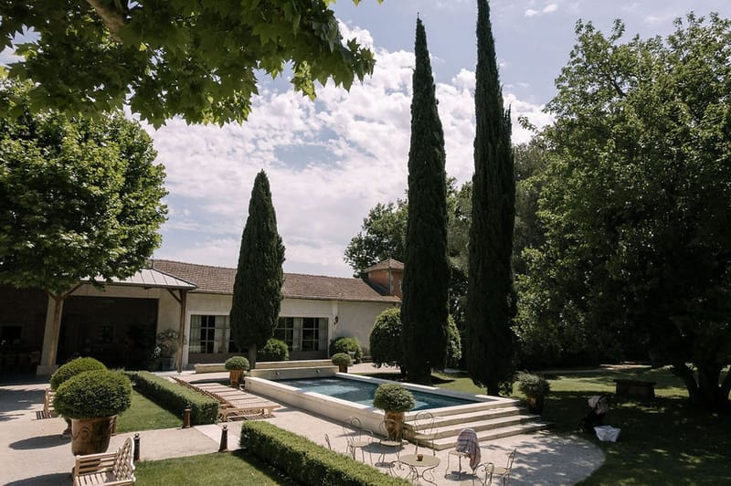 Mas D'Arvieux Provencal farmhouse pool garden with cypress trees and sun loungers in Provence