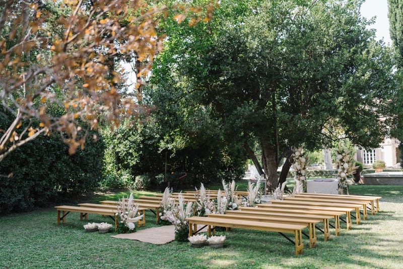 Mas D'Arvieux ceremony aisle and floral arch set beneath an oak tree