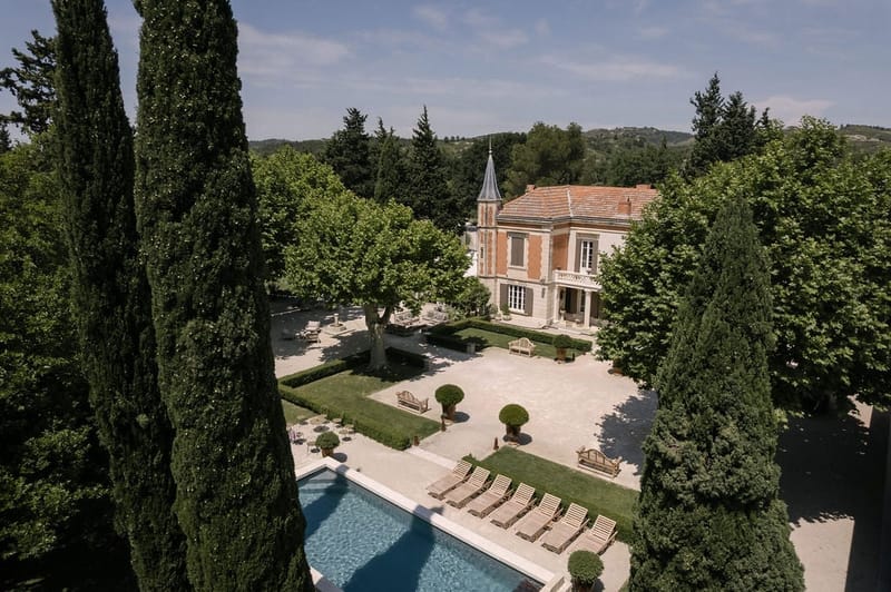 Aerial view of Mas D'Arvieux chateau, pool and grounds in Provence