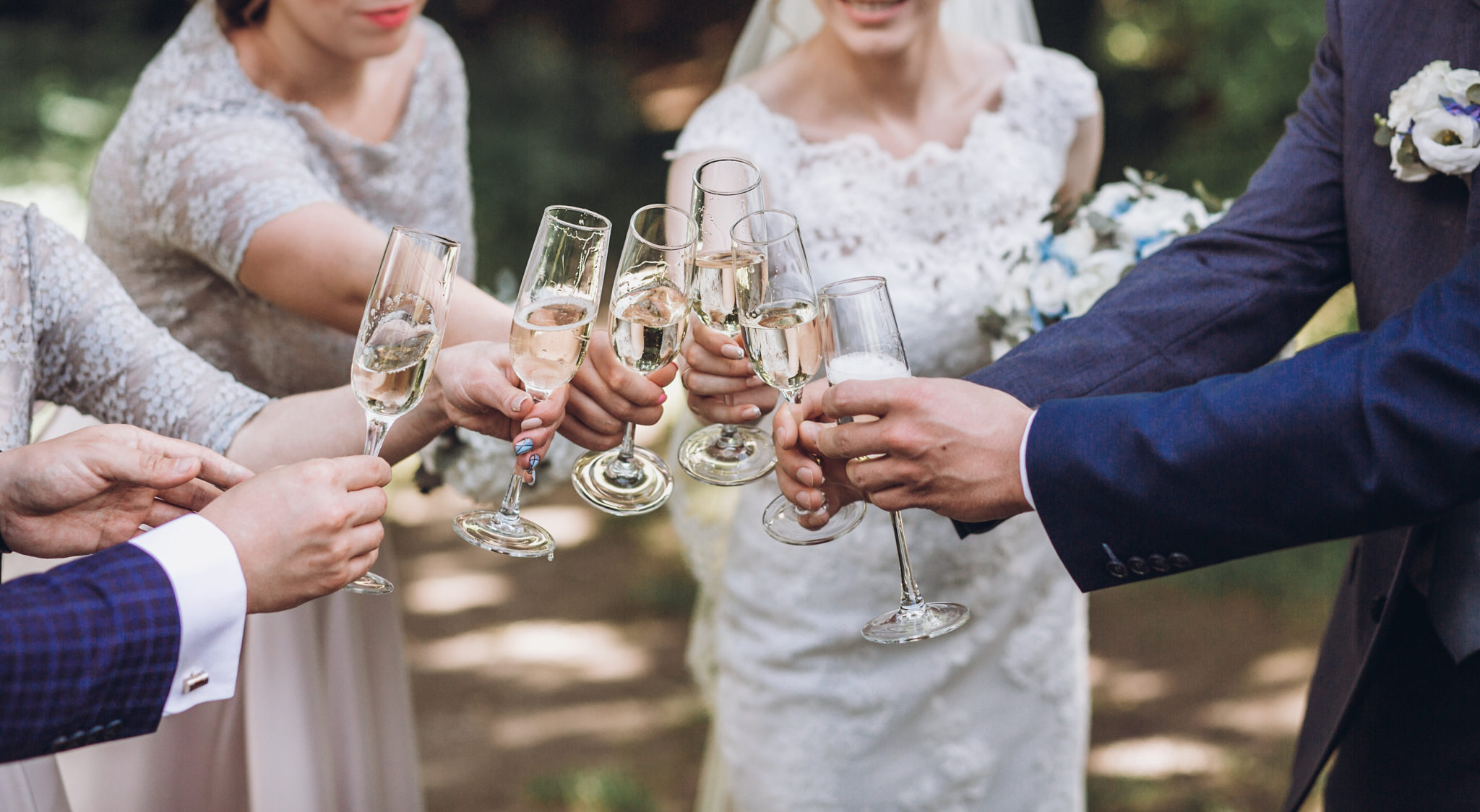 happy group of people toasting with champagne. hands holding gla