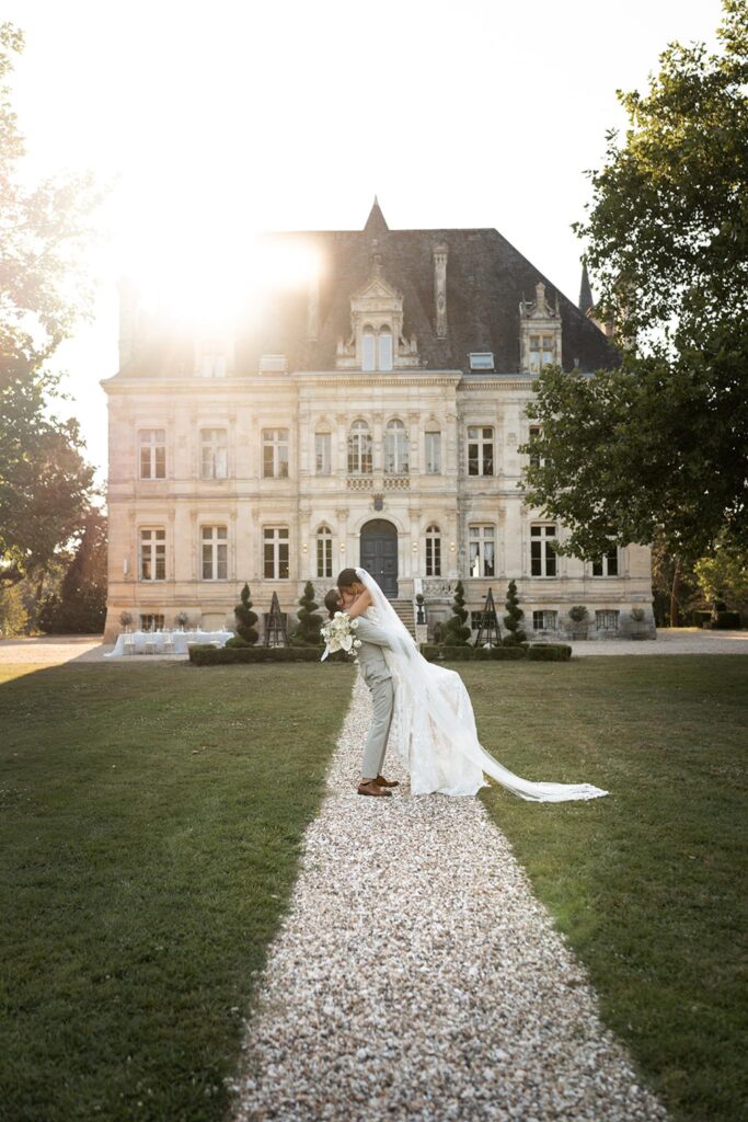 de la valouze a.bukowska bride groom carry kissing chateau background