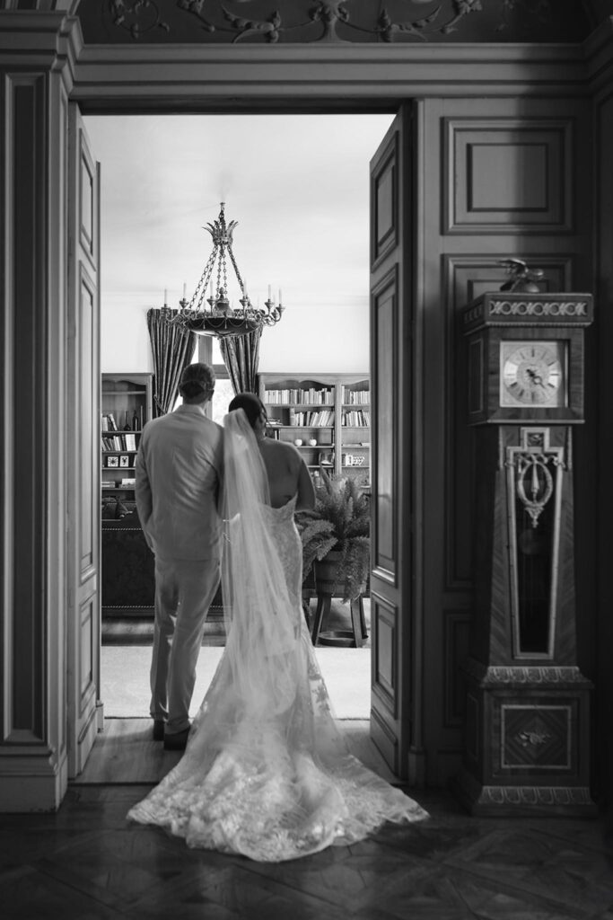 de la valouze a.bukowska bride groom looking outside long trail veil