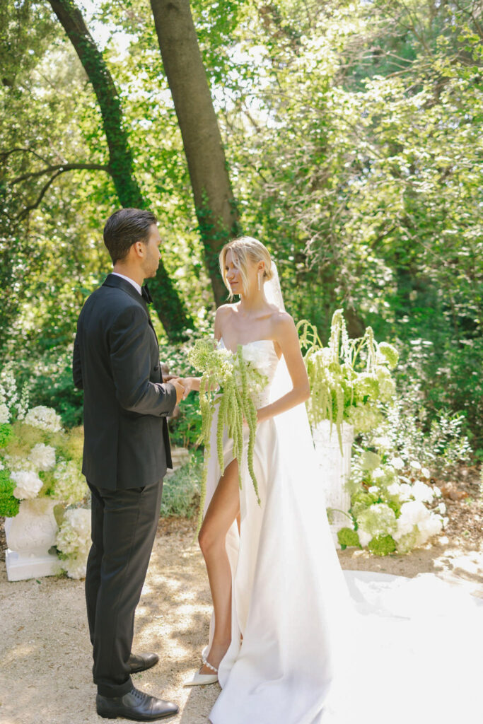 domaine de lamanon ivory romance roxane nicolas french wedding style bride groom standing big bouquet white high slit dress