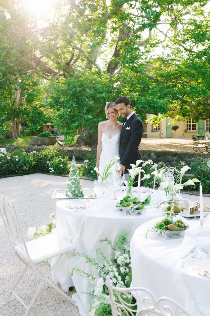 domaine de lamanon ivory romance roxane nicolas french wedding style bride groom standing smiling reception table in garden