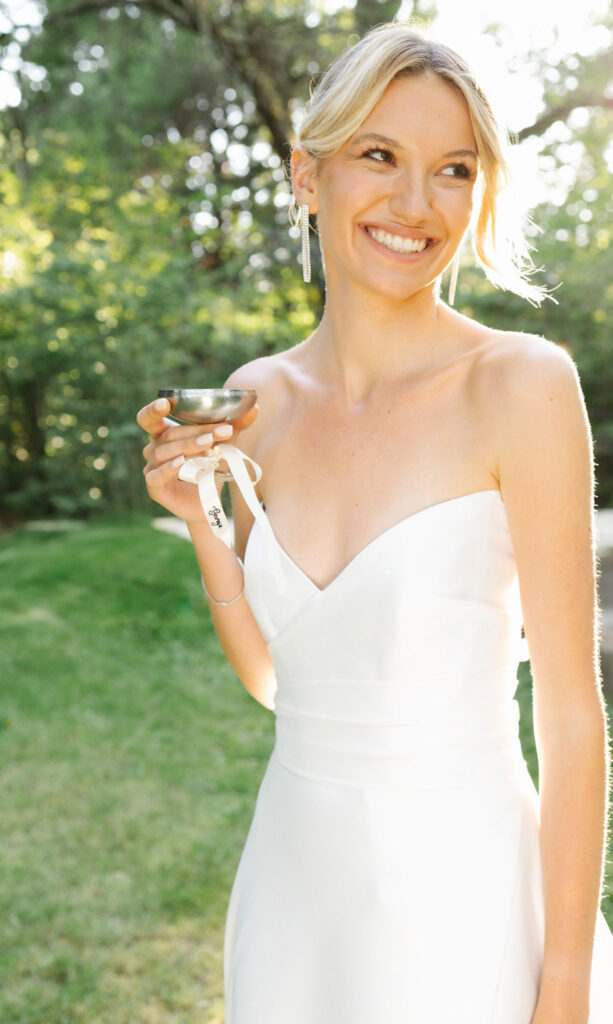 domaine de lamanon ivory romance roxane nicolas french wedding style bride holding wine glass smiling garden