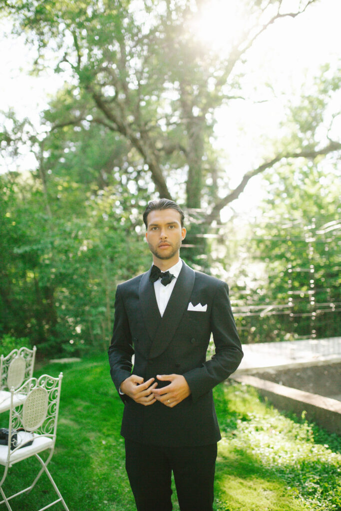 domaine de lamanon ivory romance roxane nicolas french wedding style groom black tuxedo bow tie in garden