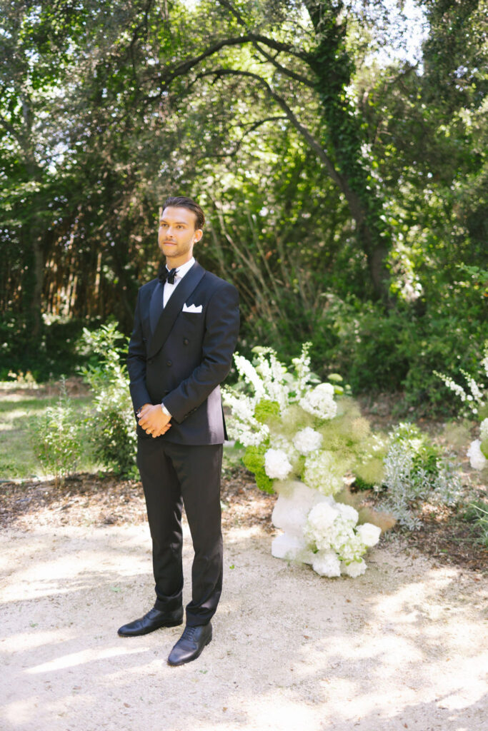 domaine de lamanon ivory romance roxane nicolas french wedding style groom black tuxedo bow tie standing