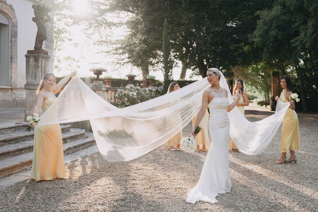 country gardens marjorie manfre french wedding style bride bridesmaid holding veil photo