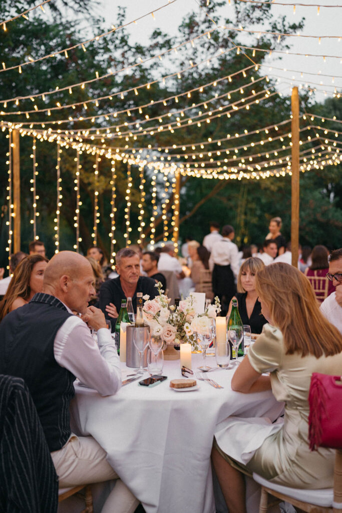 country gardens marjorie manfre french wedding style wedding guest sitting round table string lights